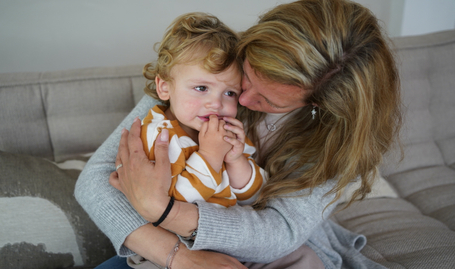 Mother holding their upset child