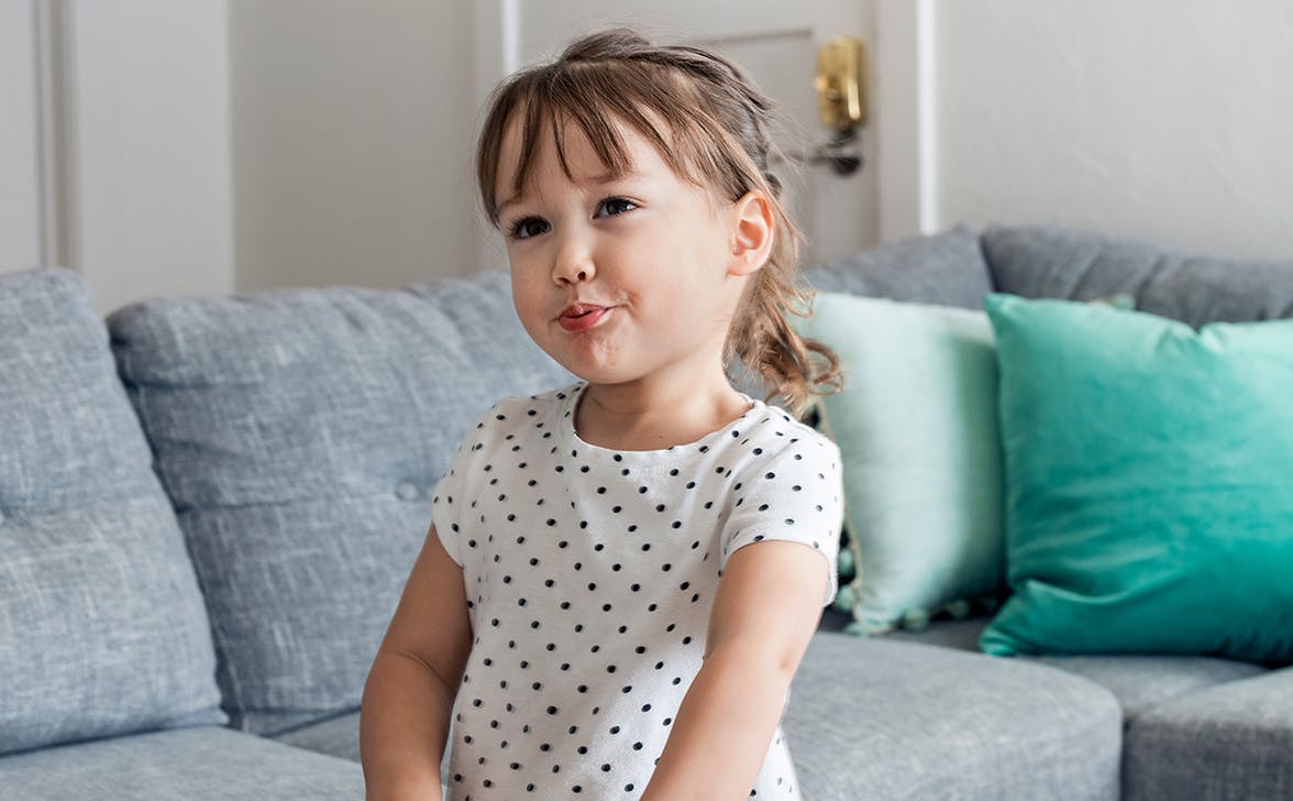 Toddler blowing air out of their mouth to make a sound