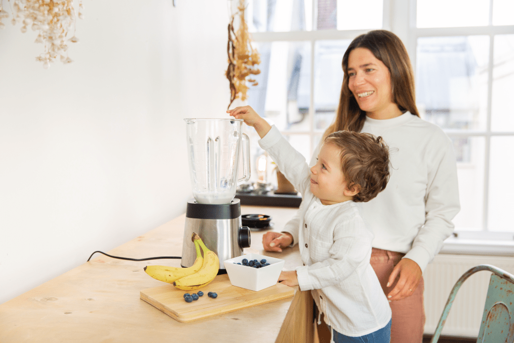 Mother and child making a smoothie together