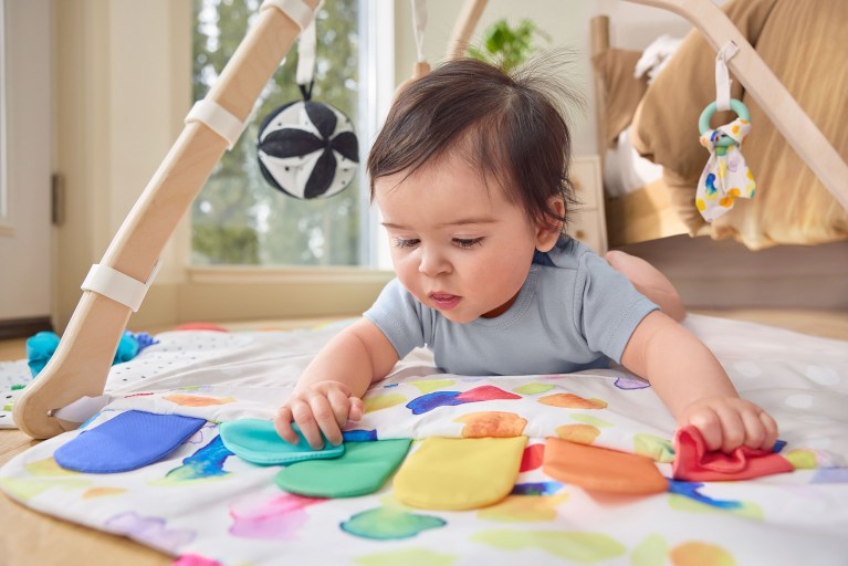 Baby laying on The Play Gym by Lovevery