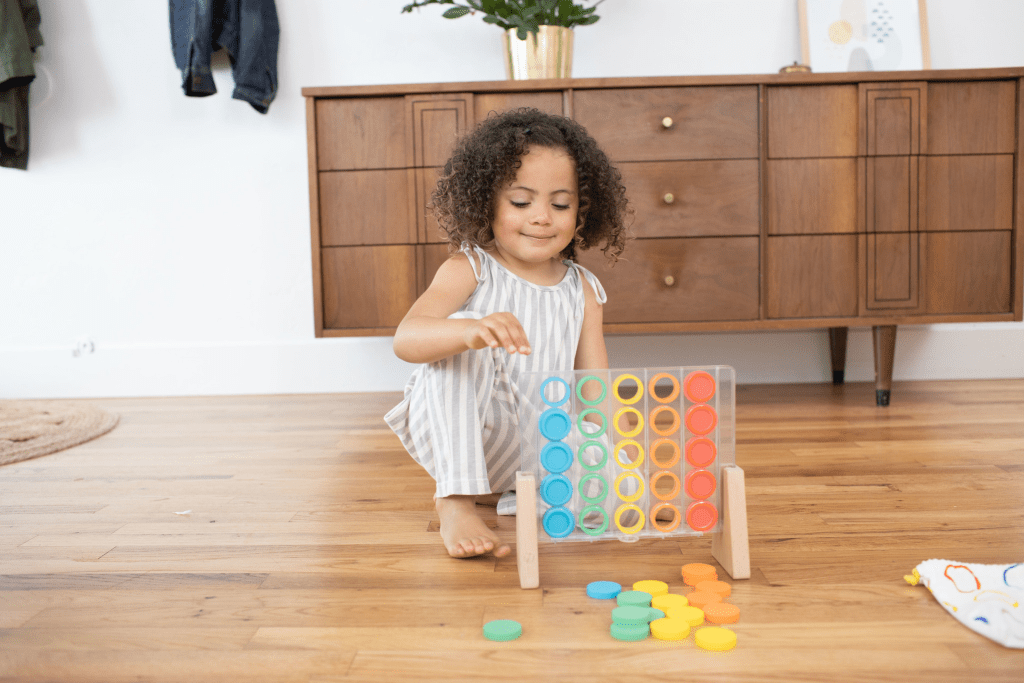 Child playing with the Drop & Match Counter Catcher from The Helper Play Kit