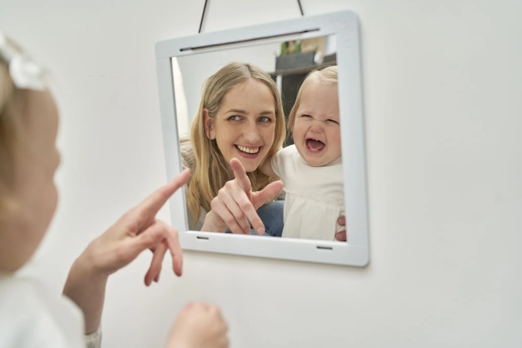 Mother and child looking into the Framed Mirror from The Charmer Play Kit