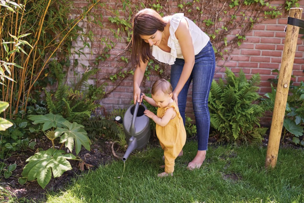 Mother and child watering plants