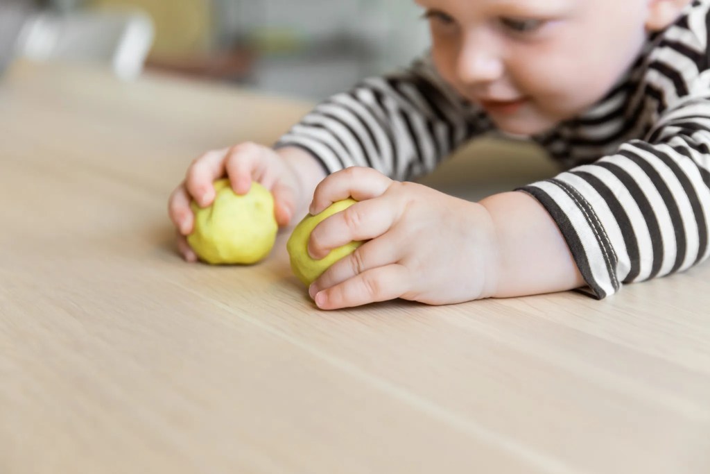 Child playing with dough