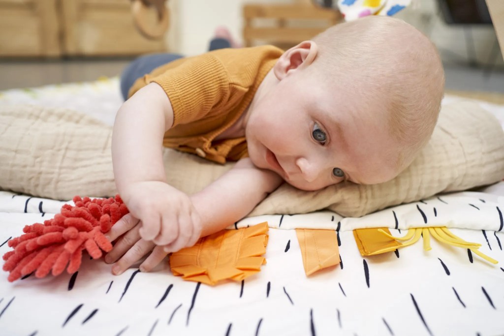 Baby doing tummy time on The Play Gym
